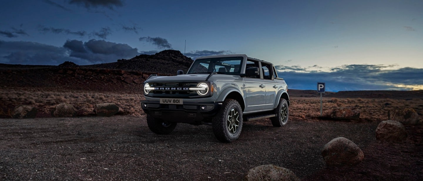 Ford Bronco driving off-road in the night