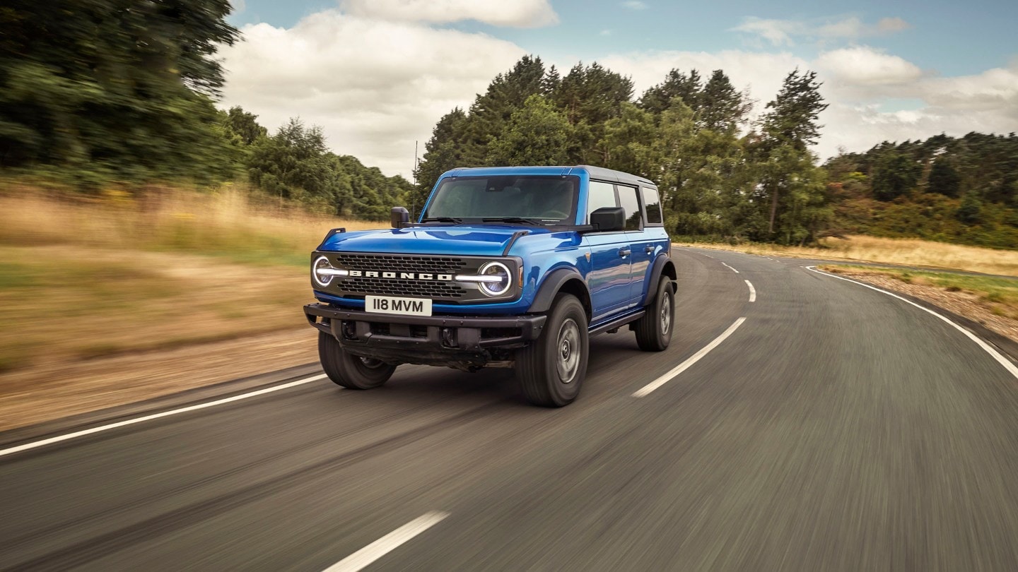 Blue Ford Bronco on a road