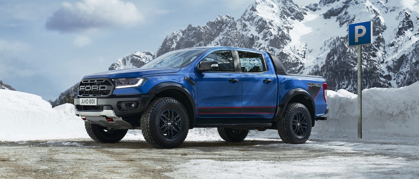 Blue Ford Ranger Raptor parked on snowy mountains Blue Ford Ranger Raptor parked on snowy mountains