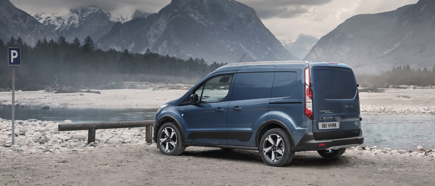 Ford Transit Connect with fisherman in countryside with mountains and lake