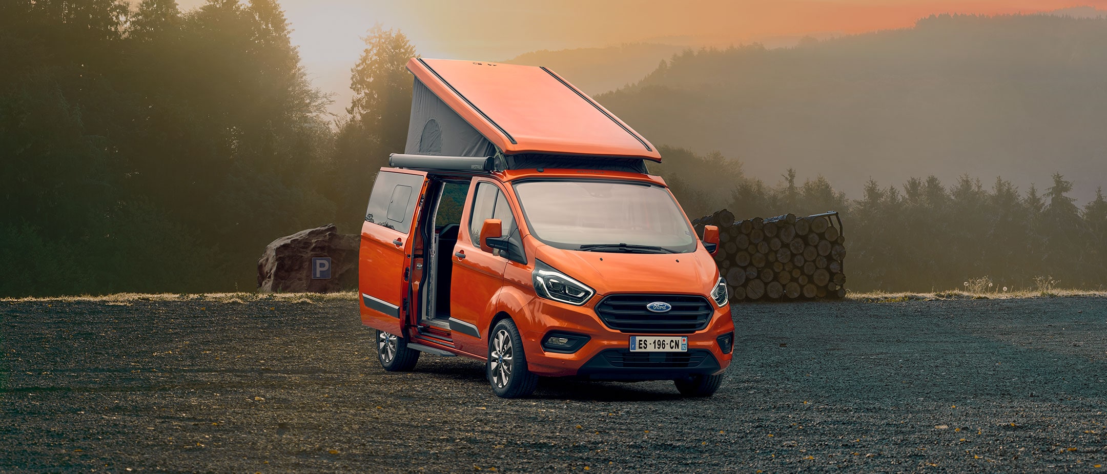 Ford Transit Custom Nugget parked in forest Ford Transit Custom Nugget parked in forest
