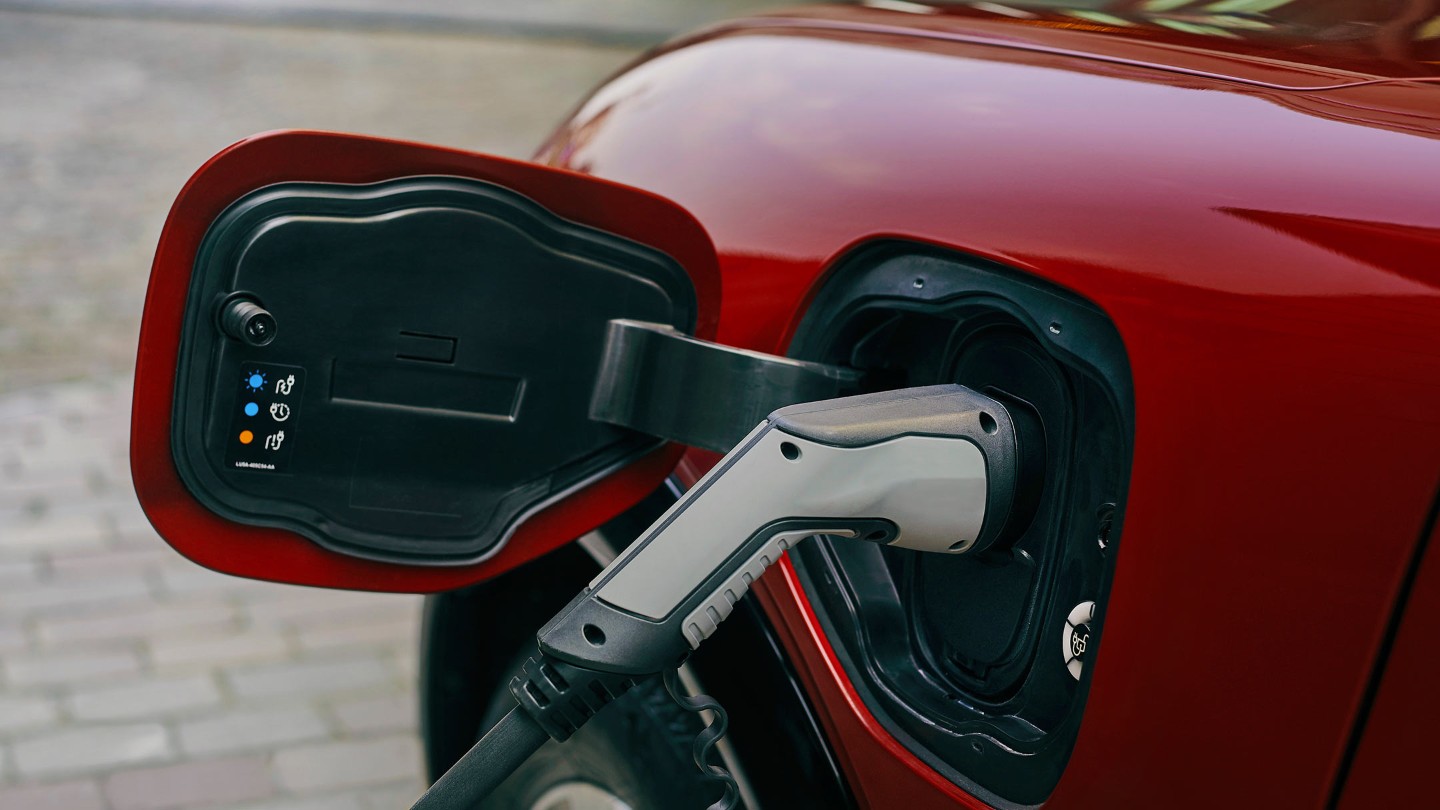 A charger plugged into an electric car