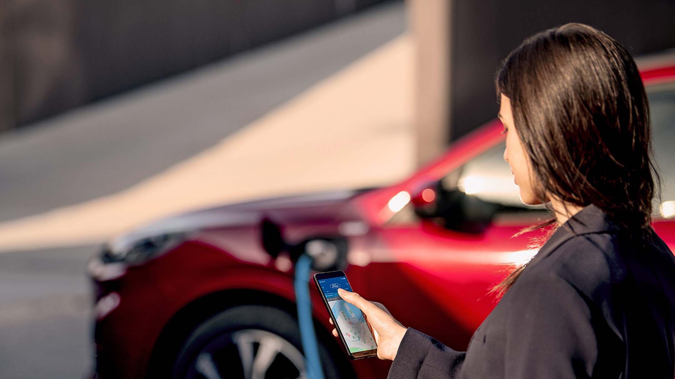 Woman holding a phone with SYNC support