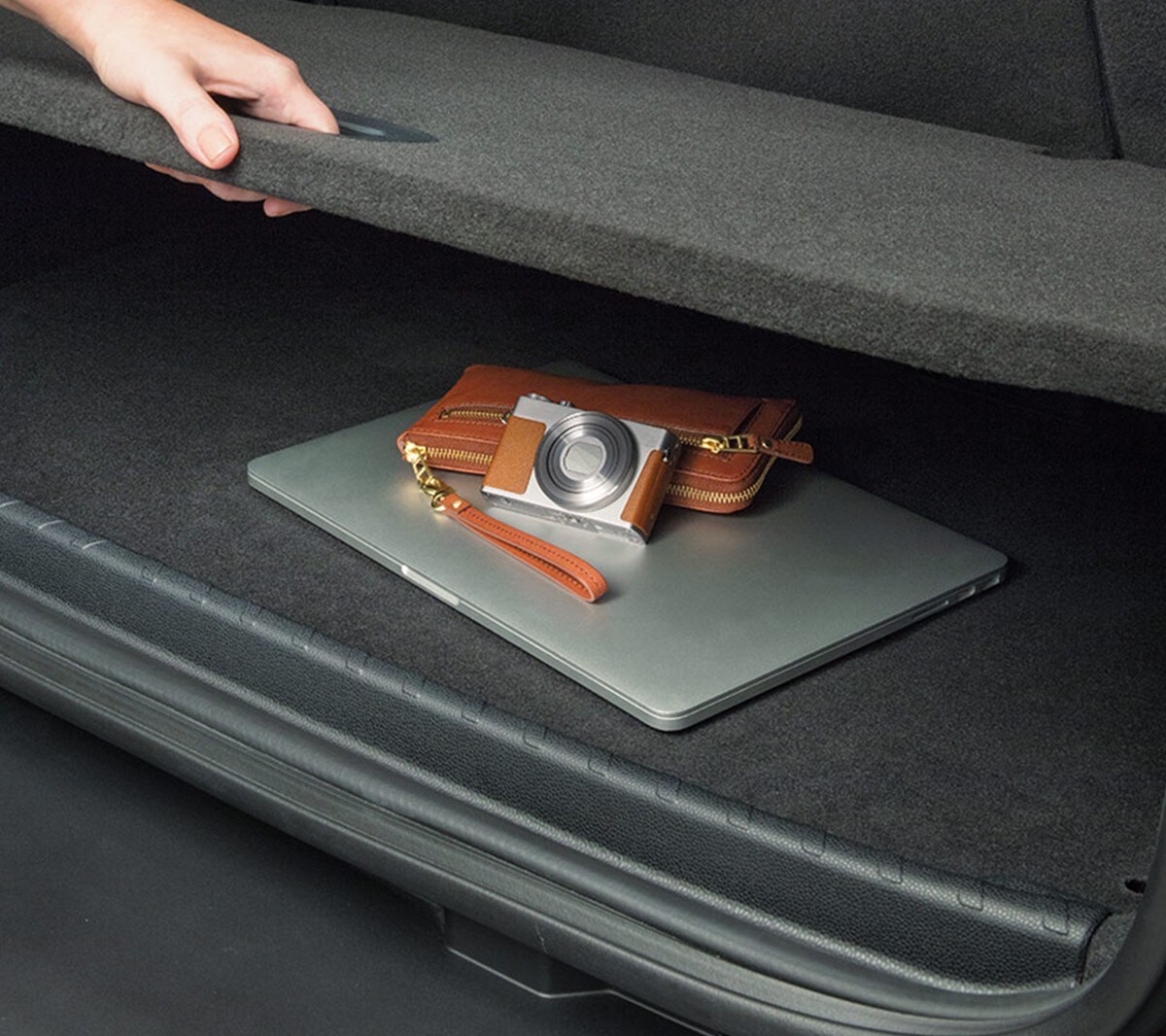 New Ford EcoSport interior with detail of storage compartment with camera and laptop