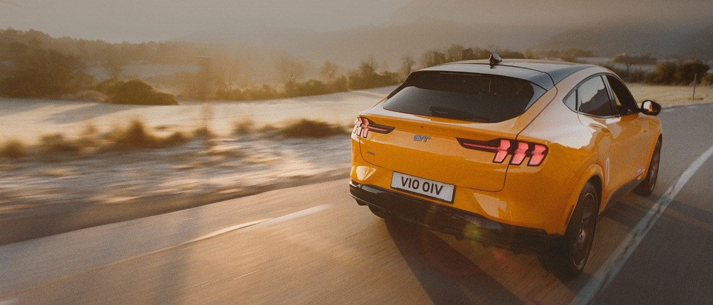 Ford car on the road with sunset on the background