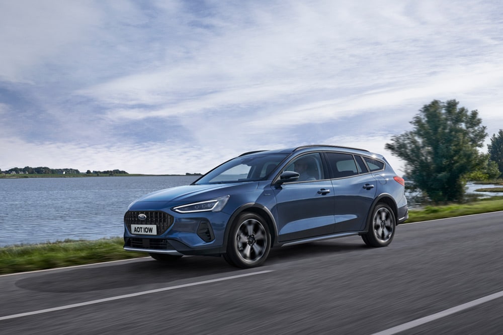 Une Ford Focus® Estate bleue roulant près d'un lac.