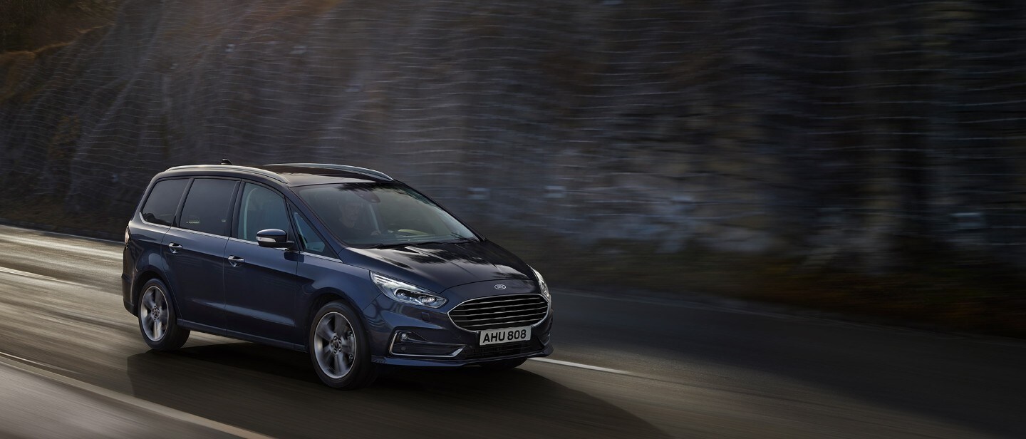 Ford Galaxy driving along a mountainside.
