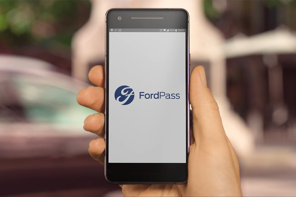 hand holding mobile phone showing FordPass App