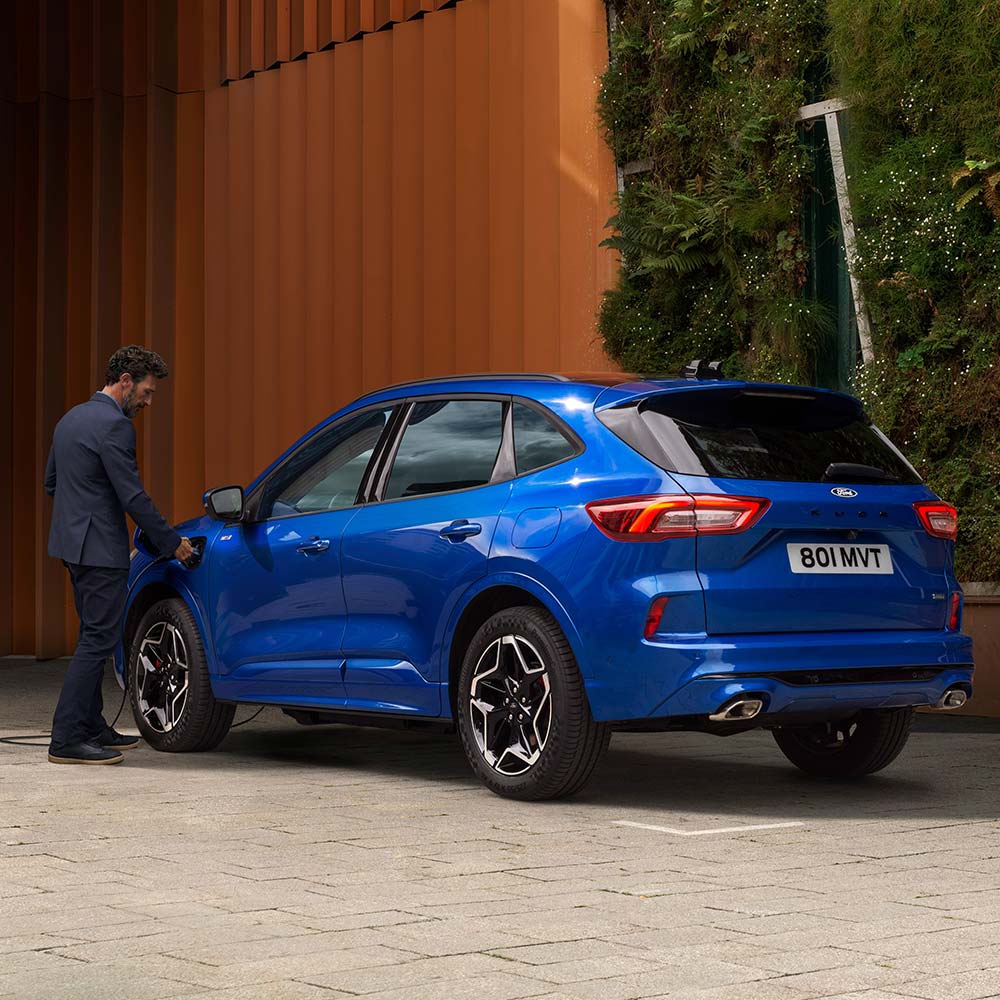 Blue Ford Kuga PHEV charging at home