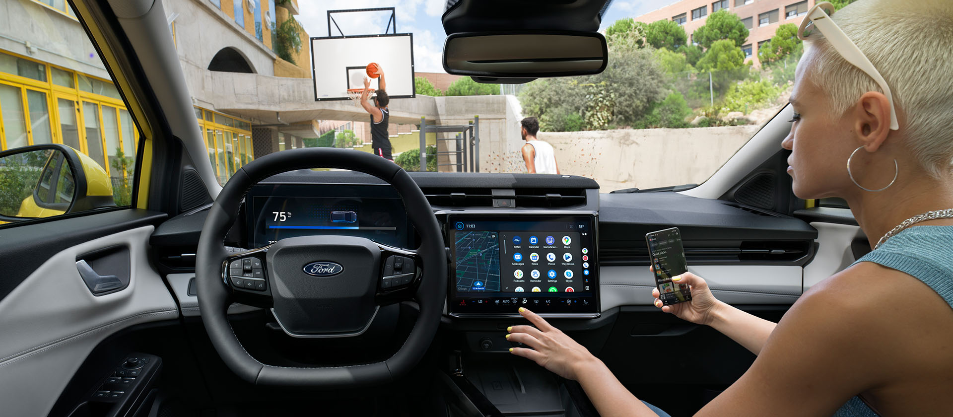 L’intérieur de la Ford Puma Gen-E® électrique, avec une personne qui synchronise sans fil son téléphone à l’écran tactile.
