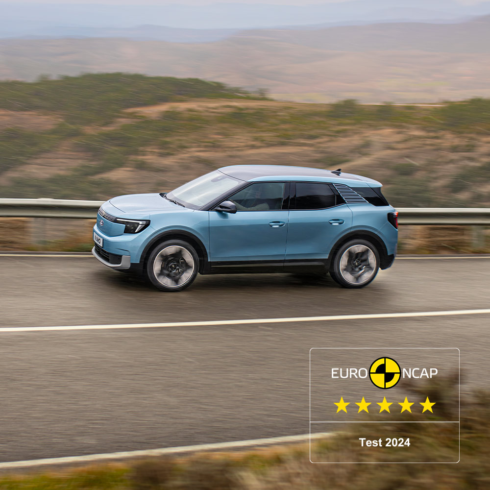 Ford Explorer bleu roulant sur une route de montagne, avec le logo Euro NCAP 2024 cinq étoiles dans le coin supérieur gauche