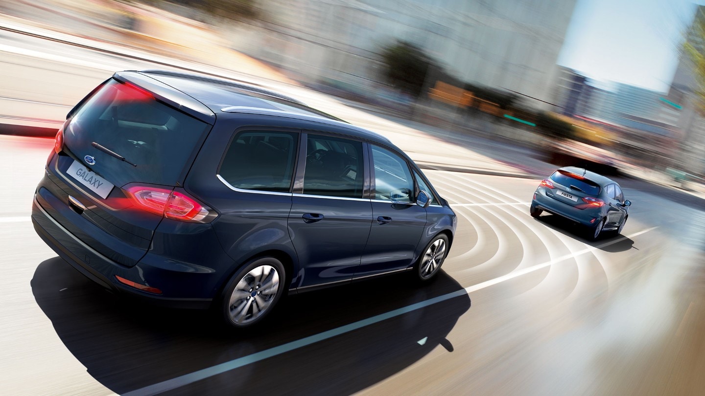 Blue Ford Galaxy cruising through the city showing the Pre-Collision Assist