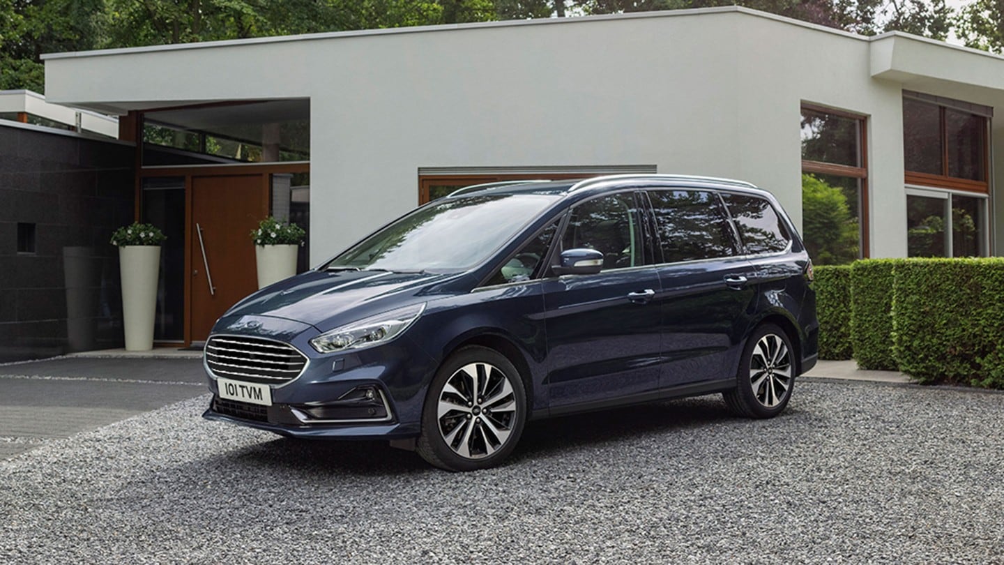 Blue Ford Galaxy parked outside a building