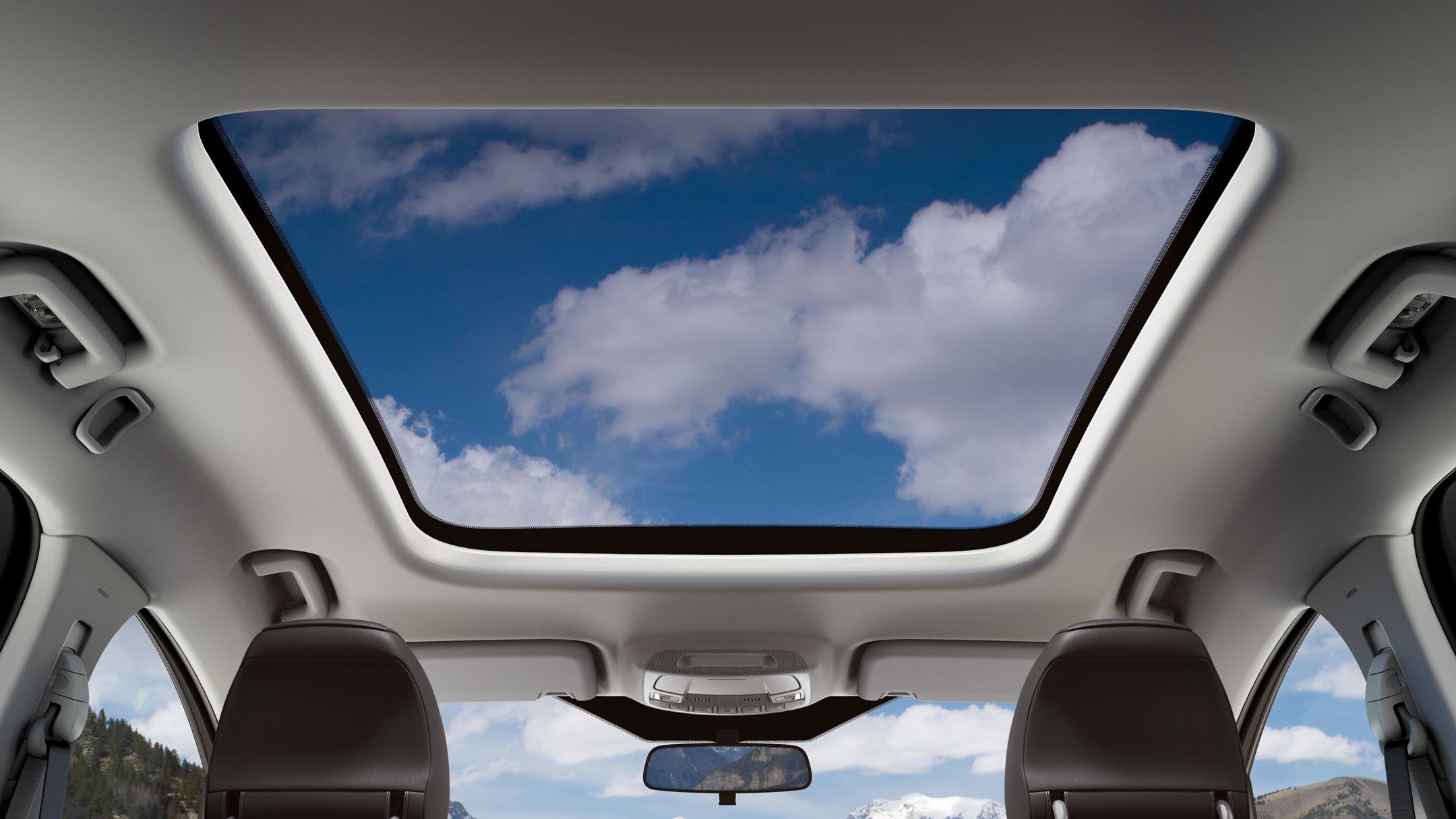Ford S-MAX sunroof with fluffy clouds in the sky