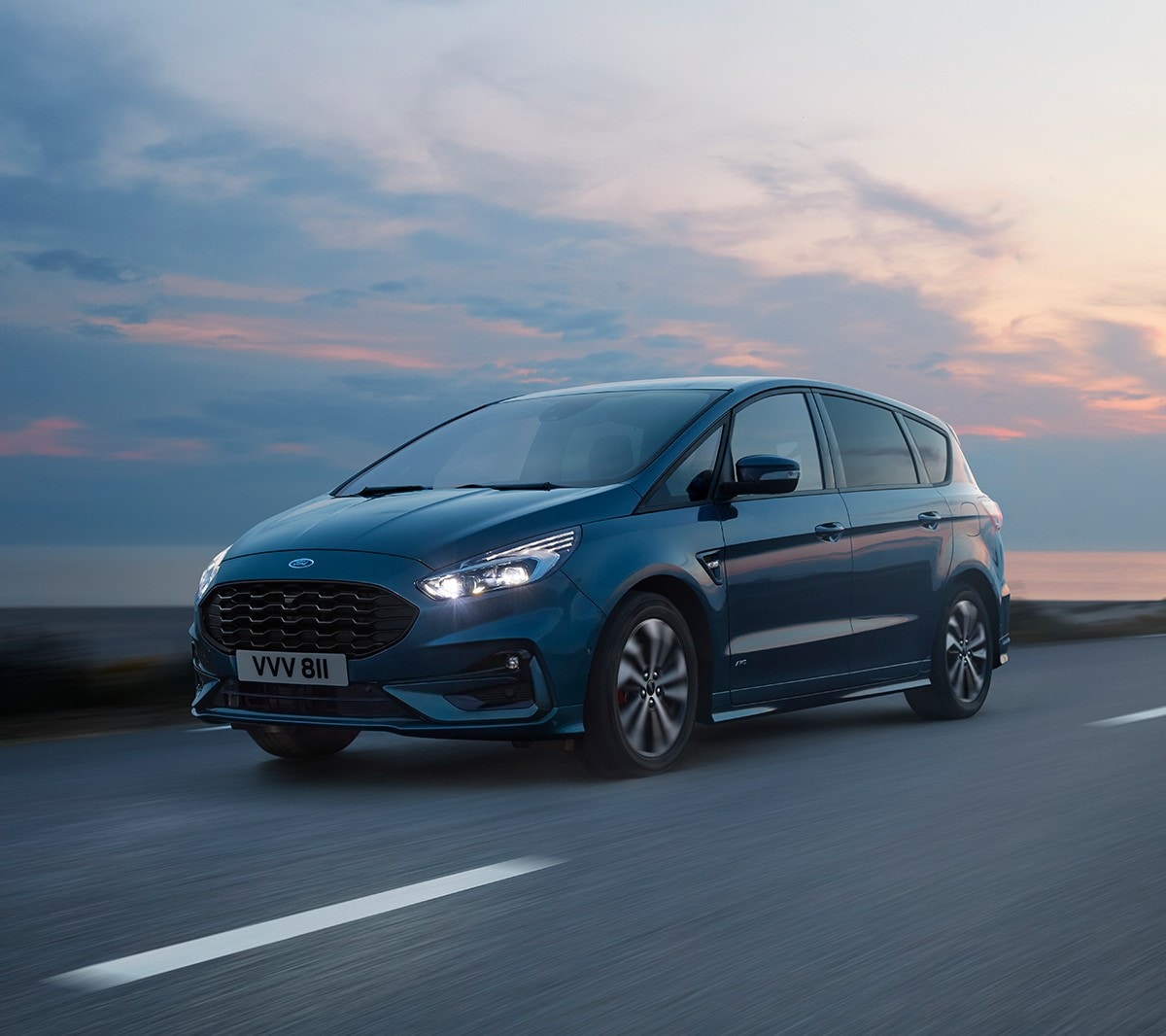 White Ford S-MAX driving on the road next to lakes