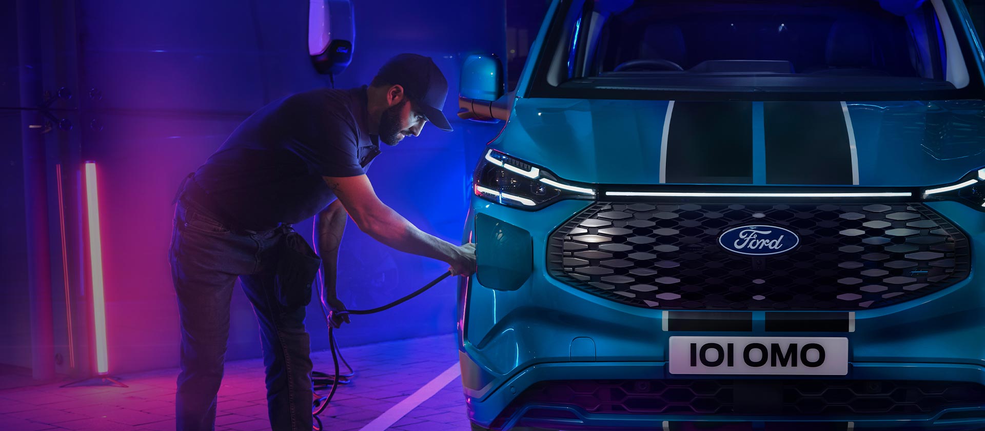 Person plugging in the All-New Tourneo Custom to charge