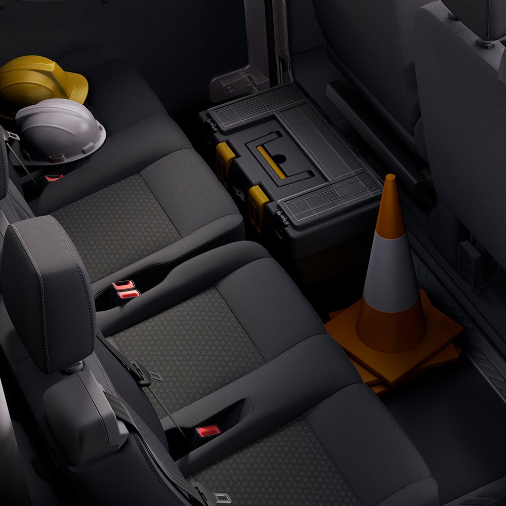 A row of dark gray seats with headrests and seatbelts.