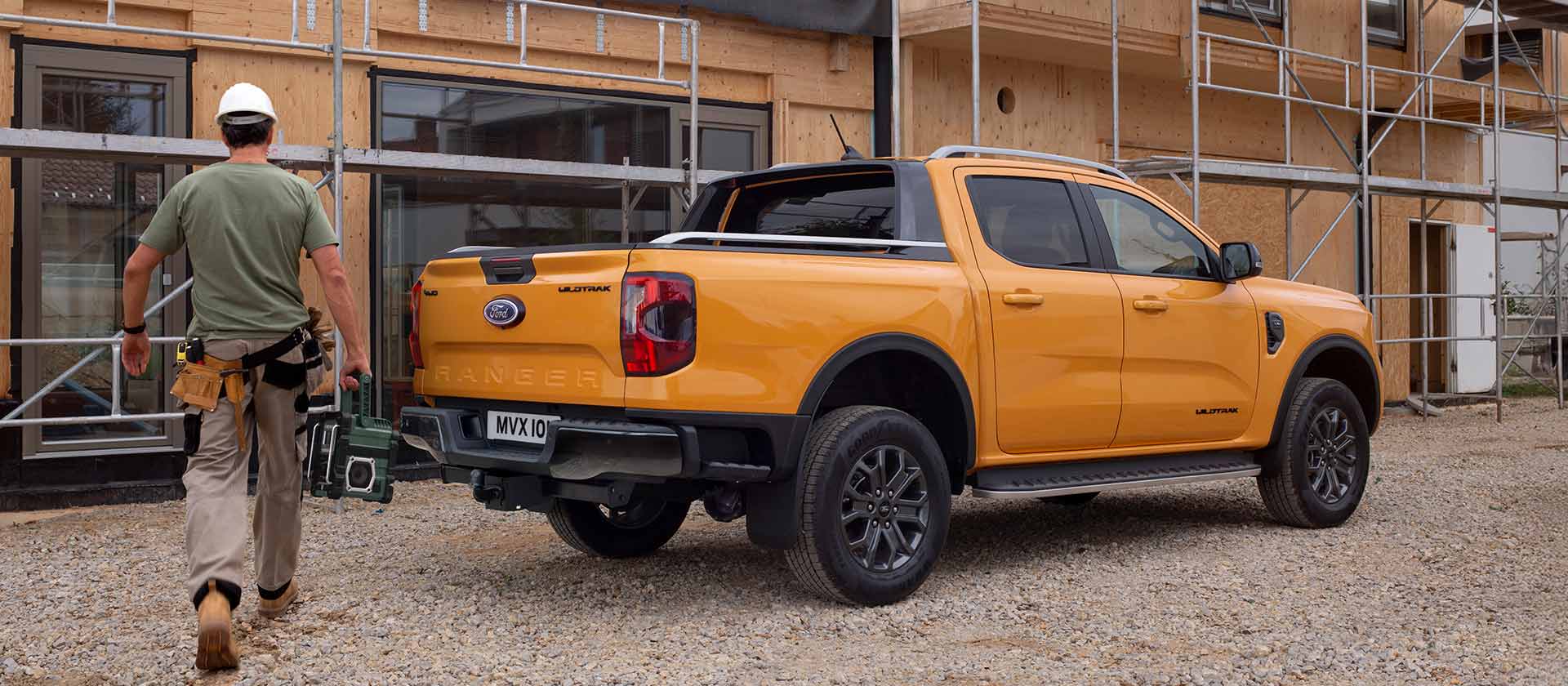 Rear three-quarter view of yellow Ford Ranger Wildtrak Double Cab at a construction site.