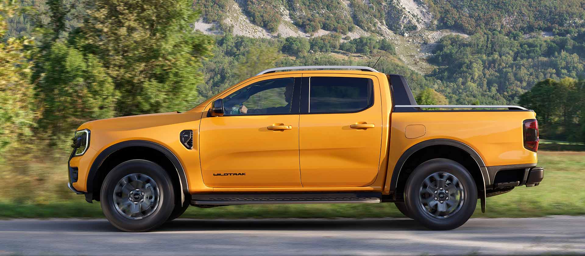 Rear three-quarter view of yellow Ford Ranger Wildtrak Double Cab at a construction site.