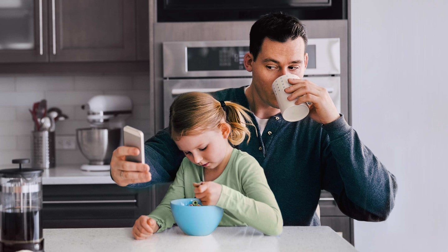 Man with kid checking mobile