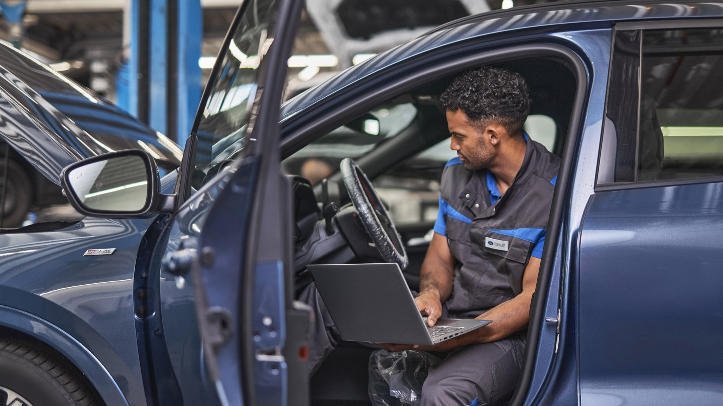 Two Ford Service engineers, inspecting vehicle